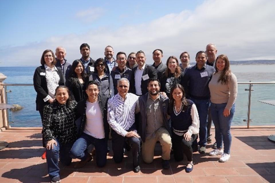 Gennaro Tecchia with a group at MBA students on a pier in Monterey, California.