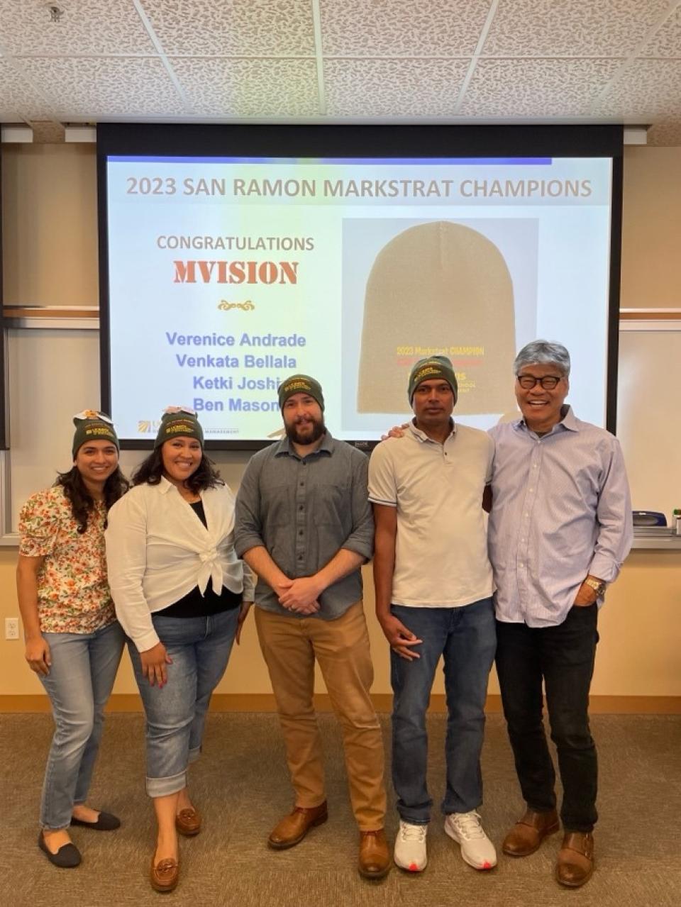 four MBA students and Marc Lowe in a classroom