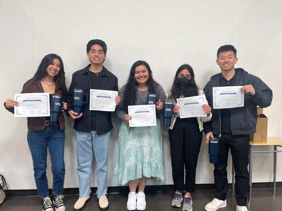 Alexis Rangel with classmates, holding up signs