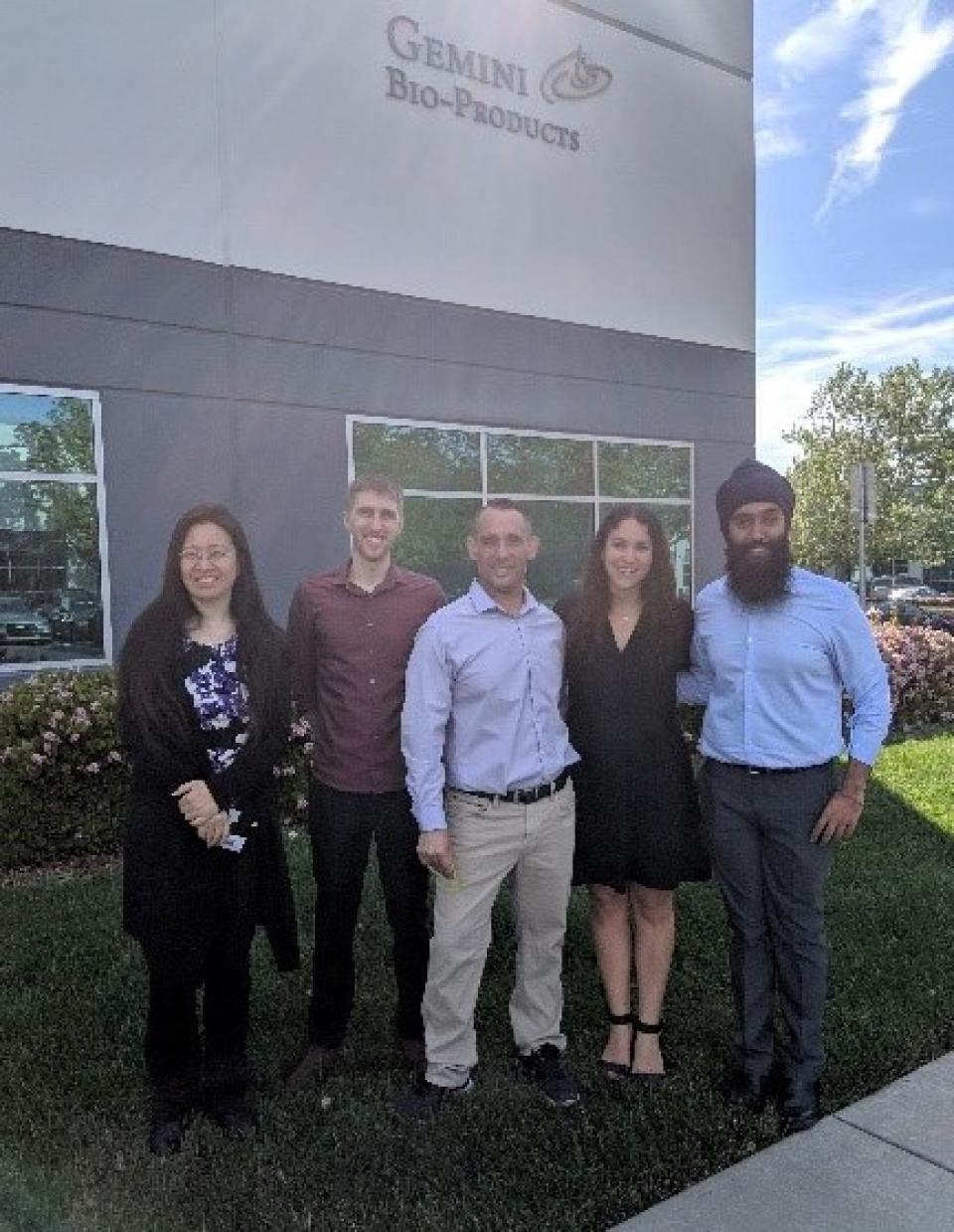 The team outdoors in front of the Gemini building