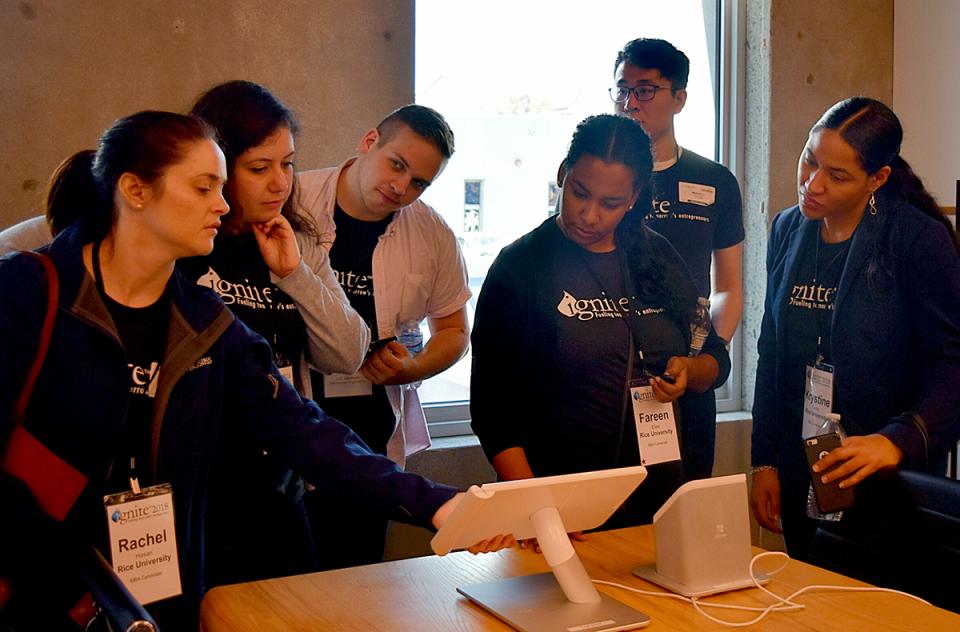 A group of attendees viewing content on a tablet