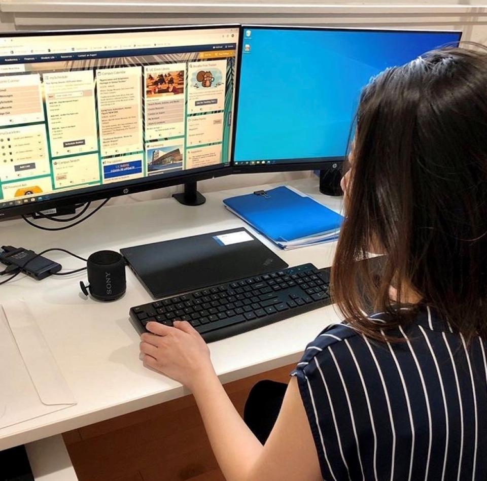 Connie Xu seated at her desk in her home office