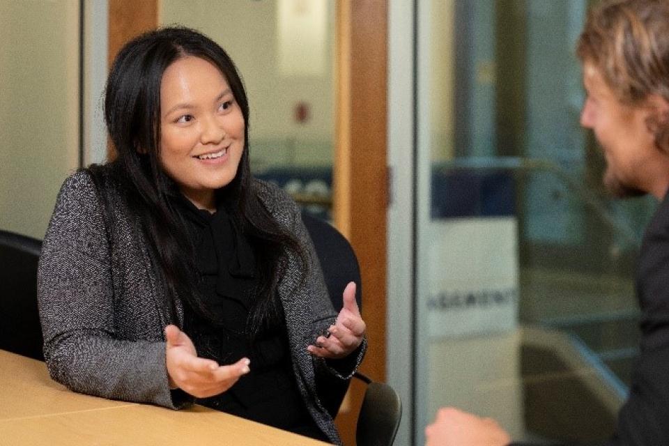 Cievia Xiong talking to a student in Gallagher Hall.