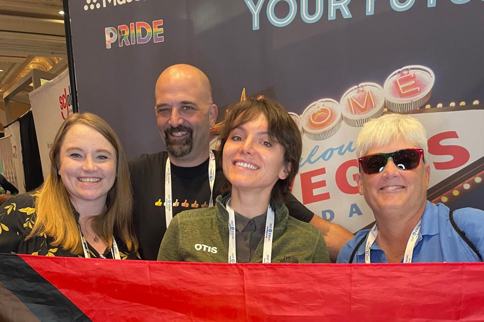 Alexandra von Klan holding a rainbow flag with her coworkers