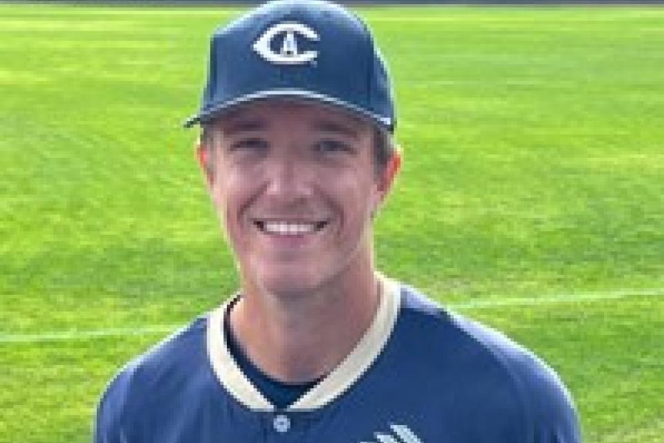 Carter Delaney wearing a baseball uniform and standing on the baseball field